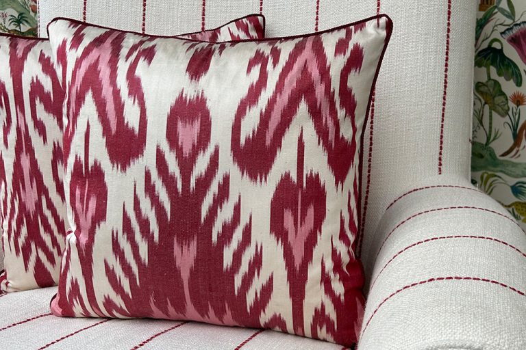 Red patterned IKAT cushions on a sofa