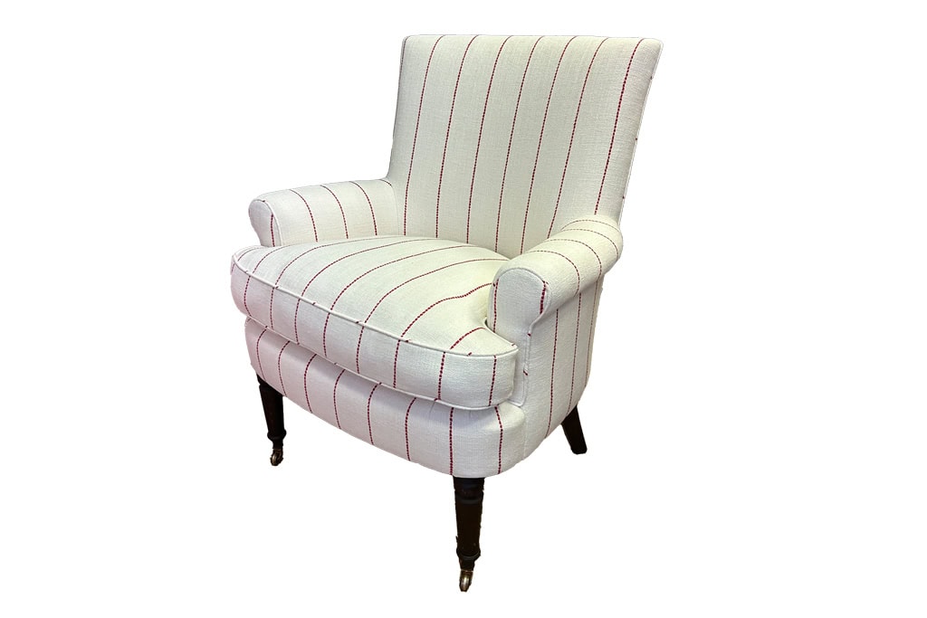 Striped upholstered armchair with wooden legs